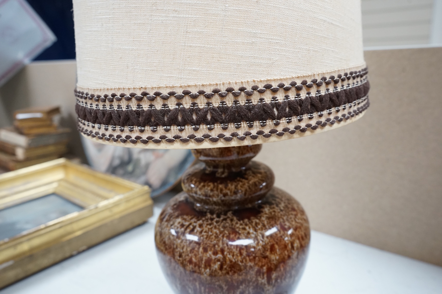 A mid century modern brown glazed ceramic table lamp and brown braided shade, 84cm including shade